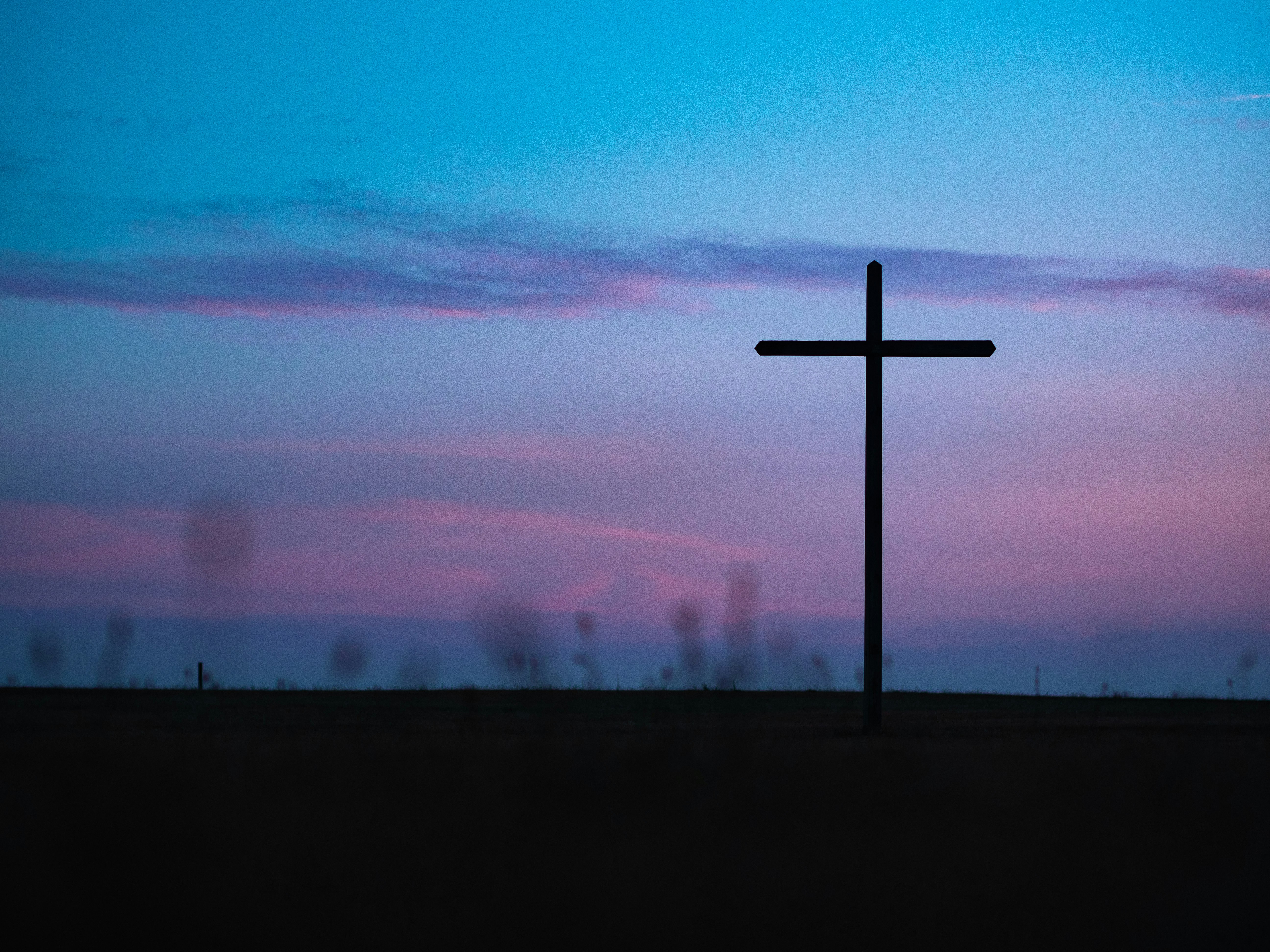 cross stand under purple and blue sky